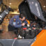 Toyota technician working beside an open forklift service compartment