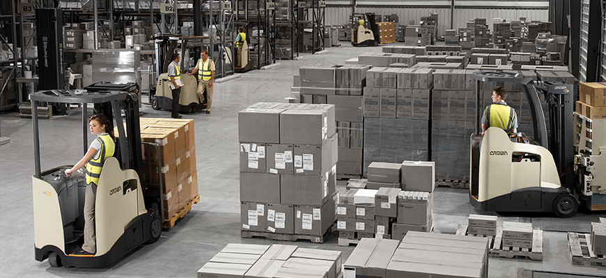 Crown trucks moving and staging pallets in a warehouse