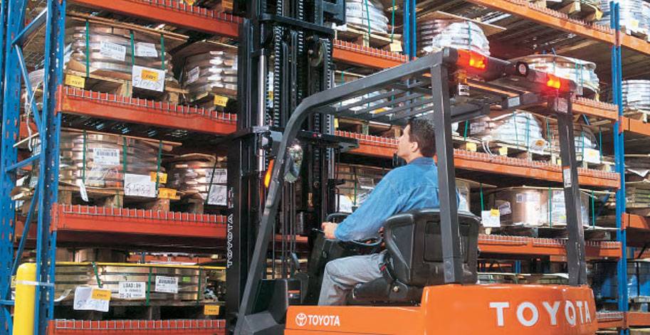 Toyota forklift operator moving through a warehouse